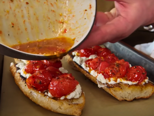 Layering Sun-dried Tomatoes & Feta On Bread photo