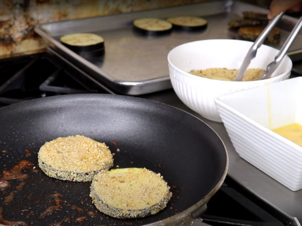 Add the eggplant slices to the pan.