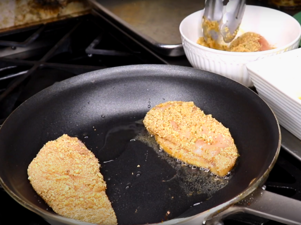 Place the marinated chicken pieces in the pan.