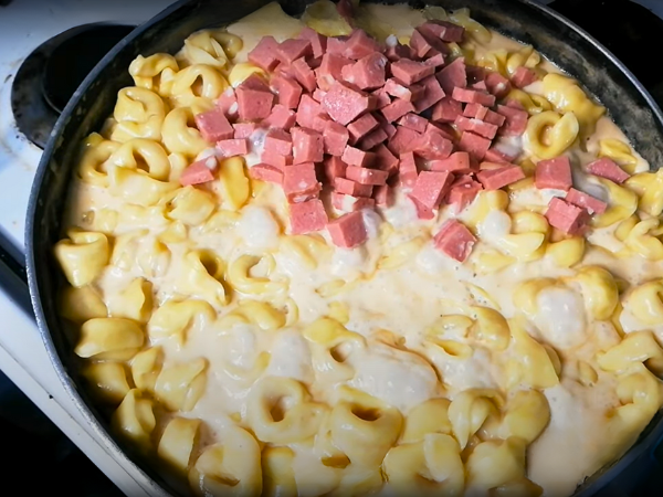 Mac And Cheese With Tortellini Step by Step Recipe - Sprinkle ½ cup of bacon bits over the tortellini and cheese mixture.