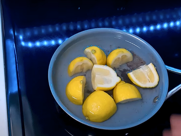 Place the lemon slices into the pan, ensuring they cover the burnt areas. 1