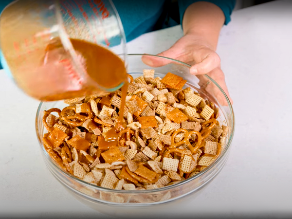 Pour the mixture over the Chex Mix base in the large mixing bowl