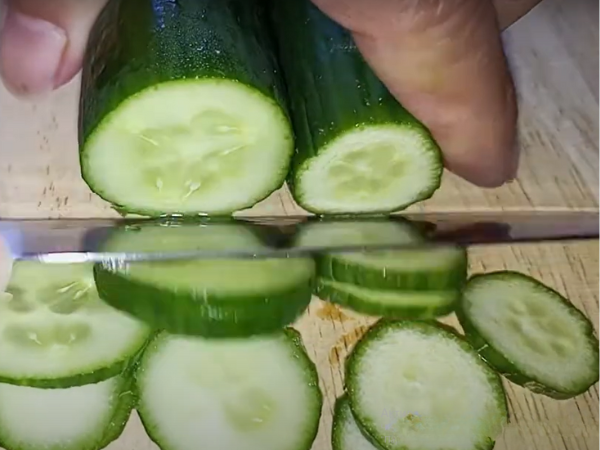 Use a sharp knife to slice the cucumbers into thin rounds.