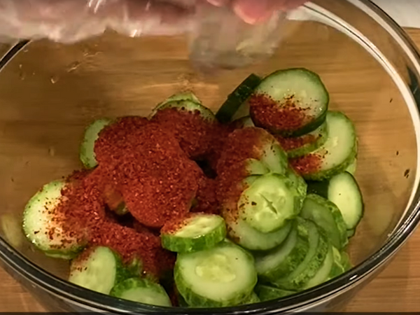 Recipe Korean Cucumber Salad (Oi Muchim) - Take a bowl and add 1 tablespoon of Korean red pepper flakes. These flakes provide the essential spicy kick.