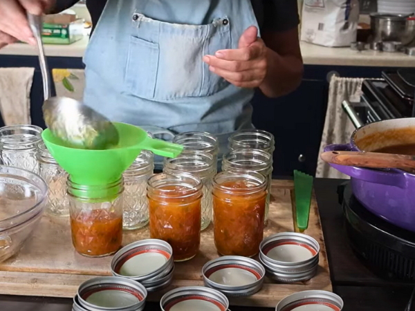 Peach Jalapeño Jam Recipe - Ladling Jam Into The Jars