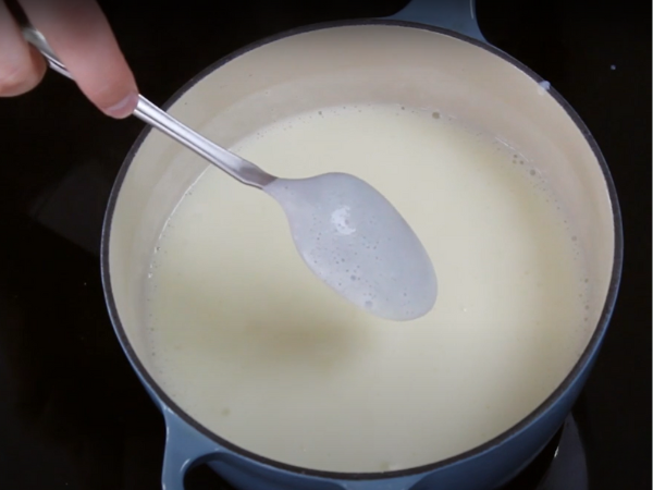 recipe Rich Vanilla Pudding - Cooking Step- Heat the mixture: Place the saucepan over medium heat. Continue to whisk until the mixture begins to thicken and bubble.